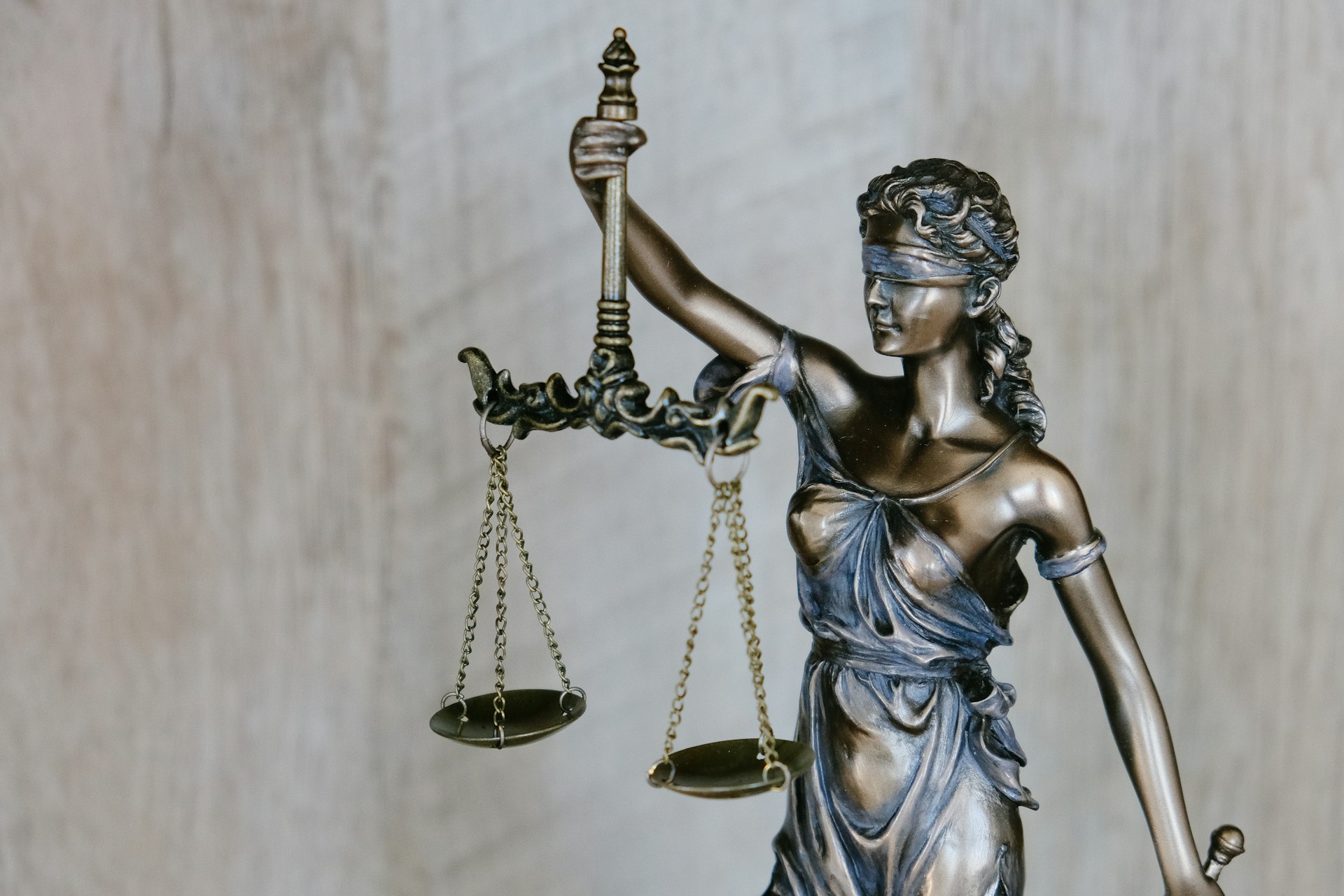 Editorial cover artwork for a UK law firm website guide, with the number 05 on a dark background and a yellow scales-of-justice illustration